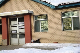 伊春市帶嶺區(qū)一排破舊的平房，房間窗戶上貼滿了“我告饒了”的字樣。