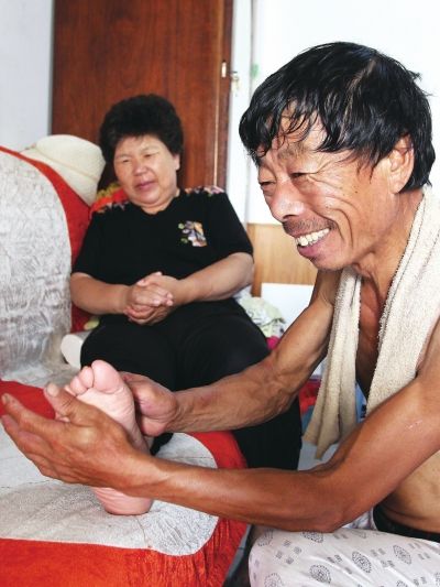 慈成富為老伴按摩。