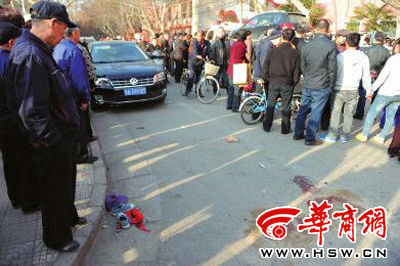 車(chē)禍現(xiàn)場(chǎng)的血跡被人用土覆蓋，旁邊則放著紅領(lǐng)巾、一雙童鞋和一頂帽子 本報(bào)記者 趙彬 攝