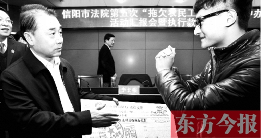 張立勇將依法執(zhí)行回來的農(nóng)民工工資發(fā)放給案件當事人游昌華，游昌華施以中國傳統(tǒng)作揖禮答謝