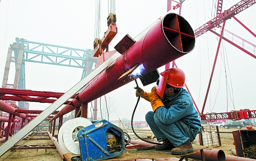 2月25日，在跨越南水北調(diào)總干渠的鄭州新鄭南段十里鋪公路橋施工現(xiàn)場，建設(shè)者在緊張地施工。