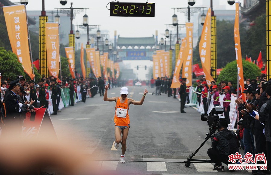 一名選手抵達終點后，高舉雙手慶祝。